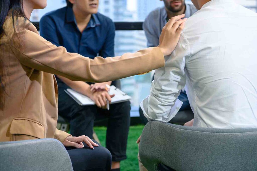 A group of people holding an intervention for someone with substance use disorder