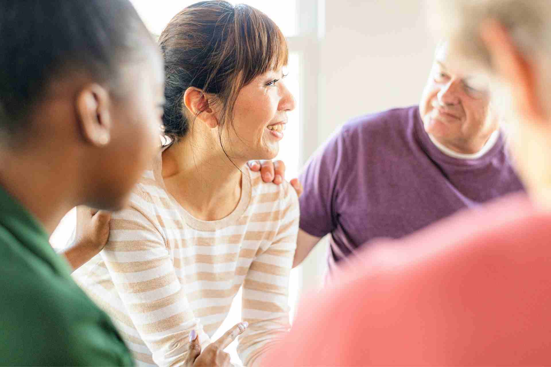 Therapist meeting with an adult client during an individual substance use counseling session in a private office.