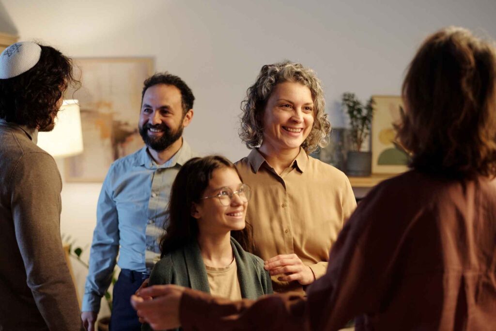 Family members welcoming a loved one home after addiction treatment as part of ongoing recovery support.