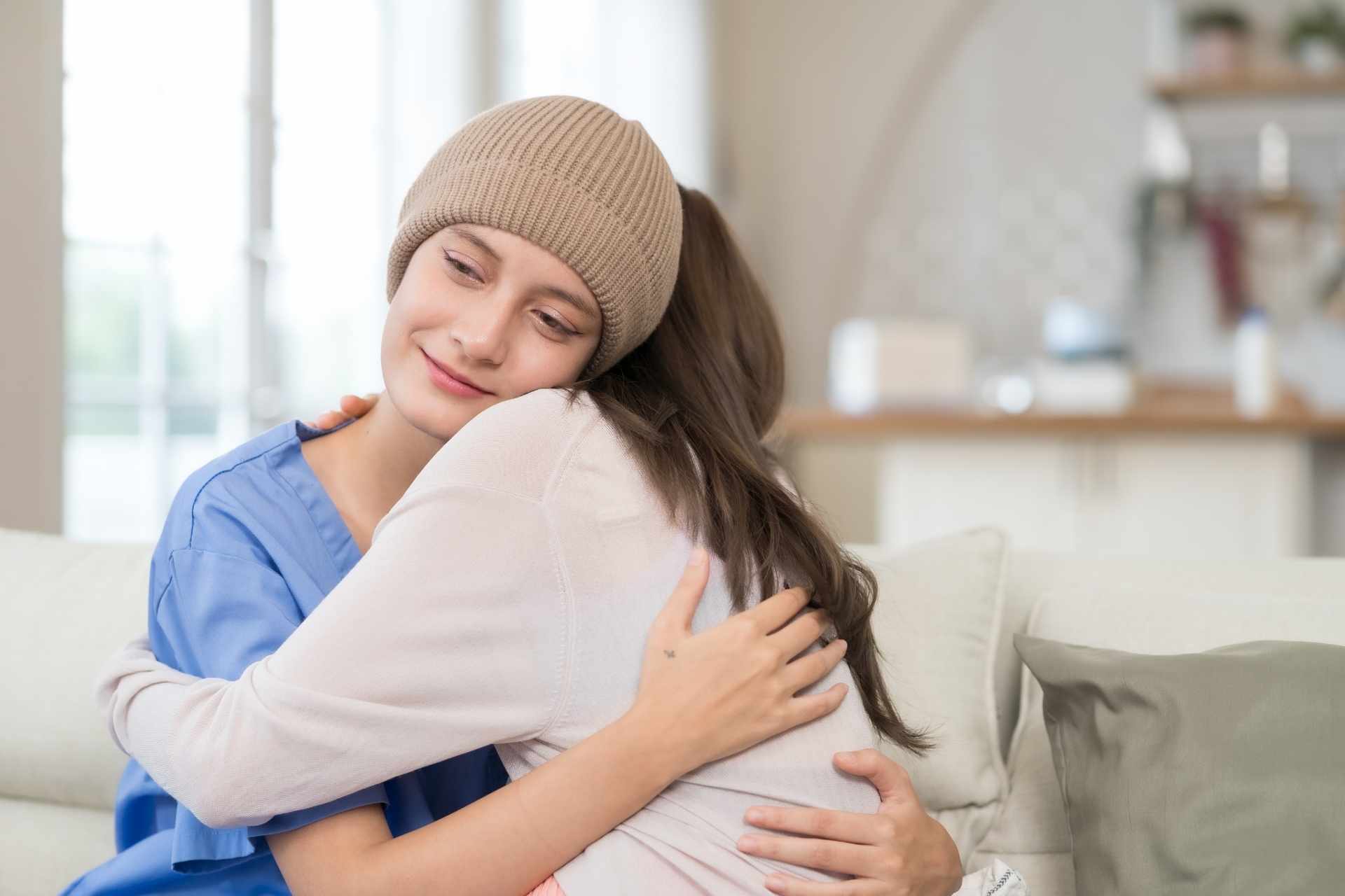 Supportive embrace between a healthcare professional and a person receiving encouragement during addiction recovery.