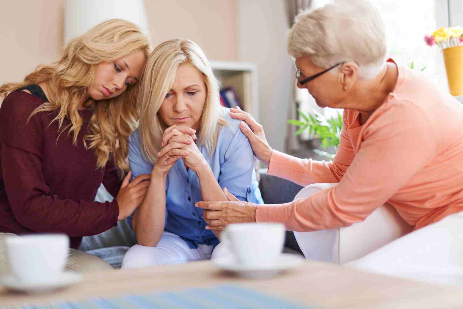 Family members comfort a loved one during addiction and dual-diagnosis recovery.