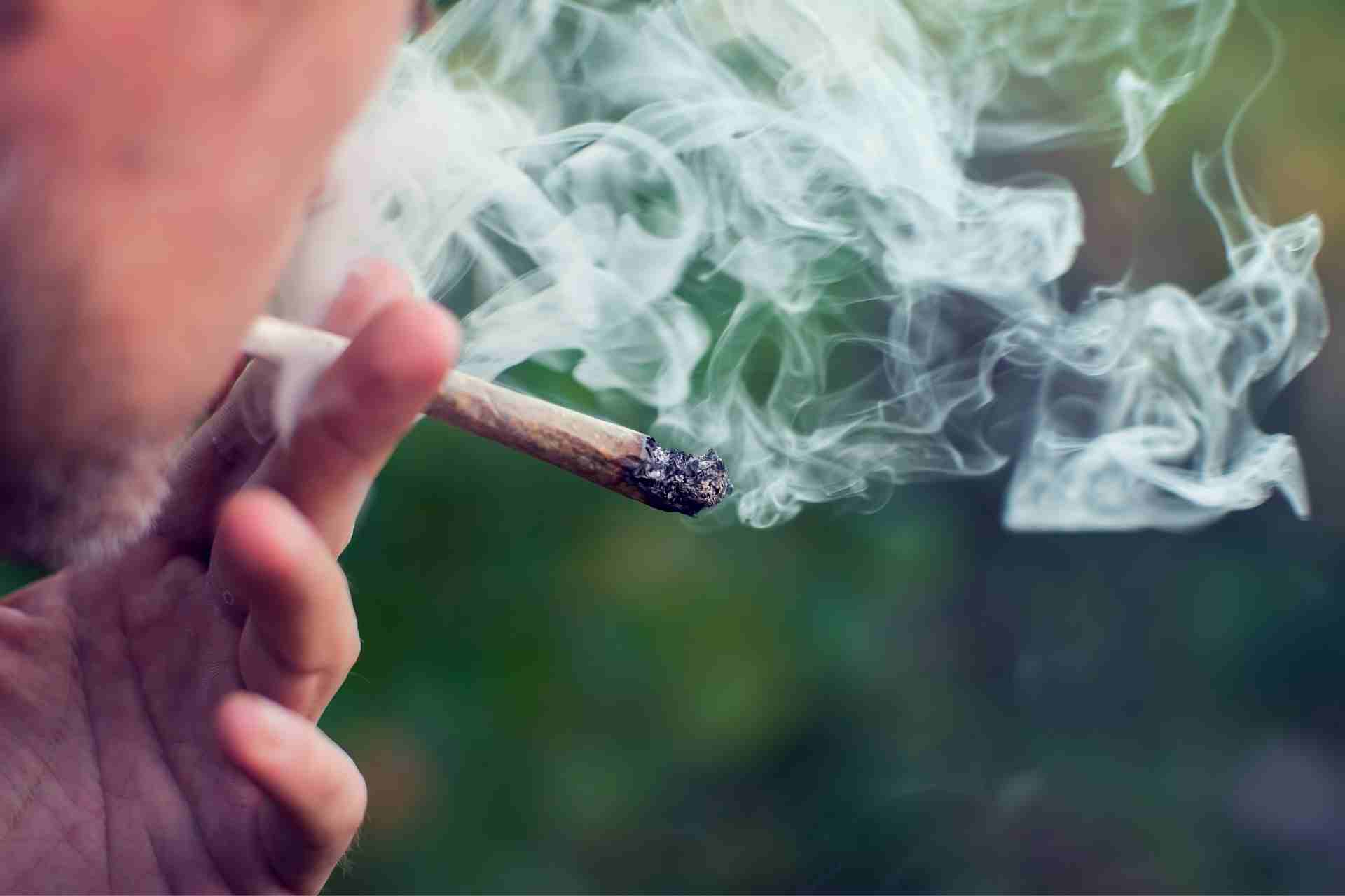Close-up of a person smoking marijuana, illustrating cannabis use disorder and marijuana addiction