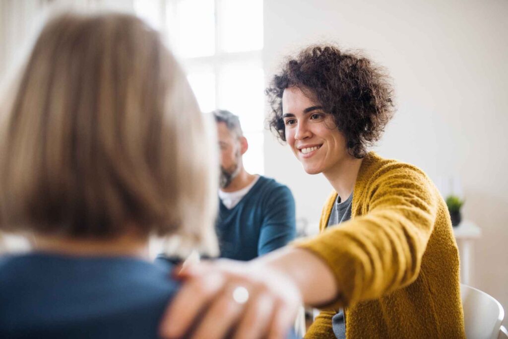 Woman participating in an aftercare support group for addiction recovery