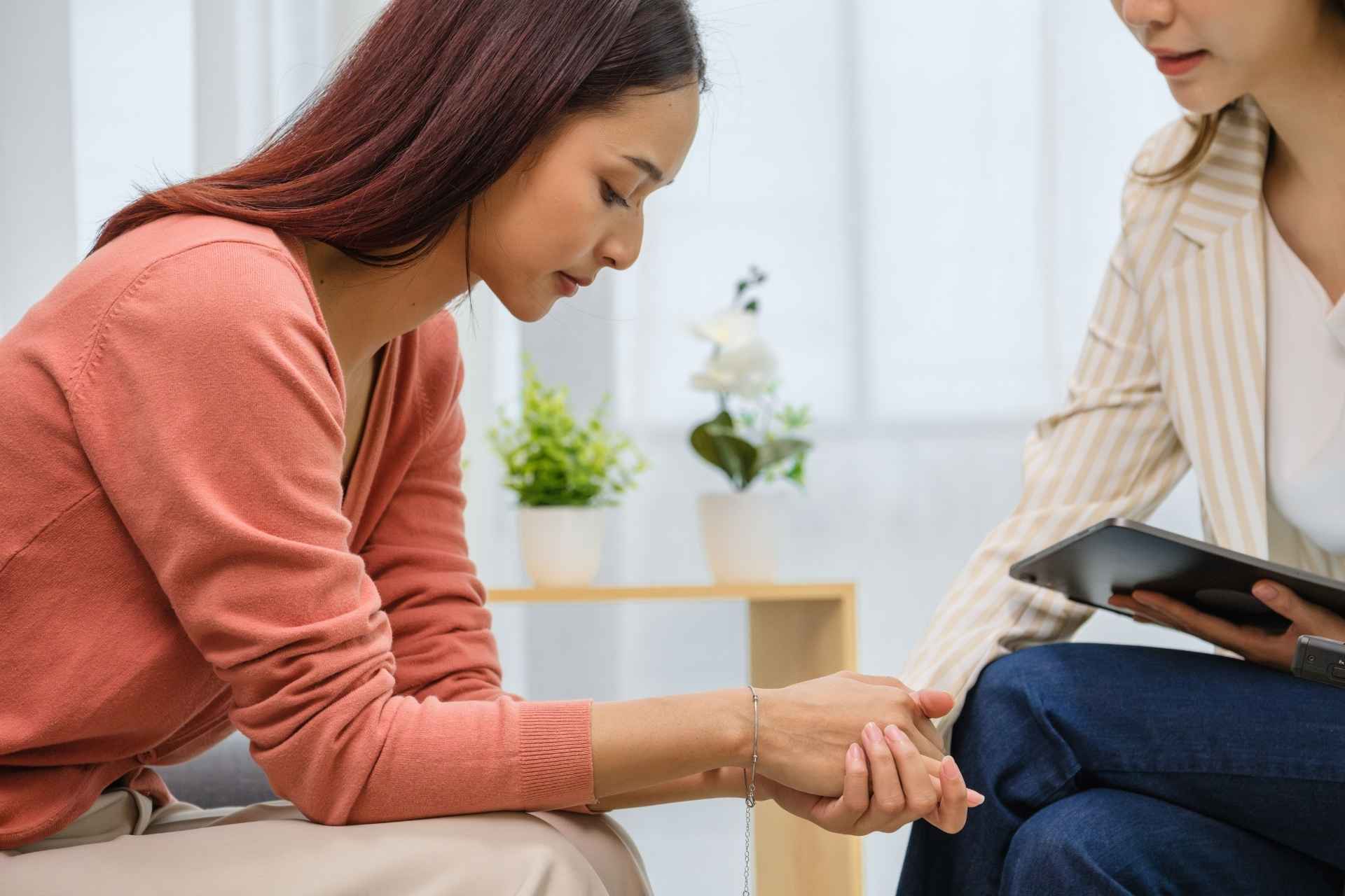 Woman receiving compassionate support during a conversation about addiction treatment and recovery.