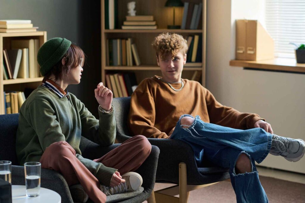 Two young adults talking during dual-diagnosis treatment for anxiety and addiction