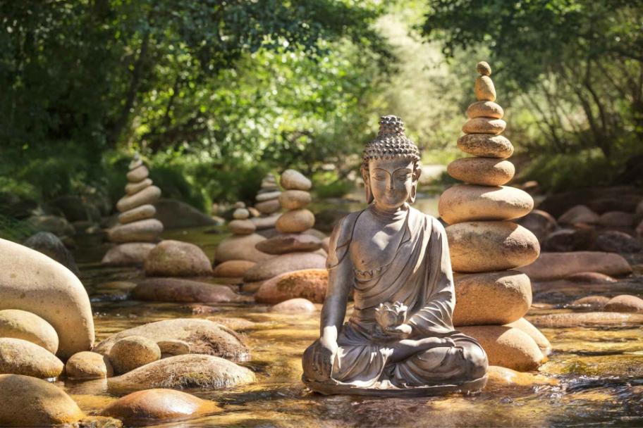 Buddha statue and balanced stones representing mindfulness in dual diagnosis treatment.