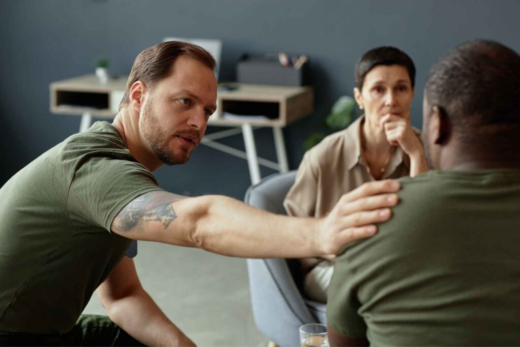 Adults participating in group therapy for PTSD and addiction dual diagnosis treatment.